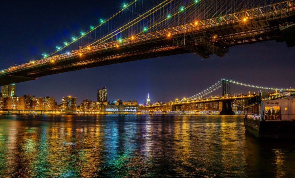 Brooklyn Bridge cables framing Manhattan skyline